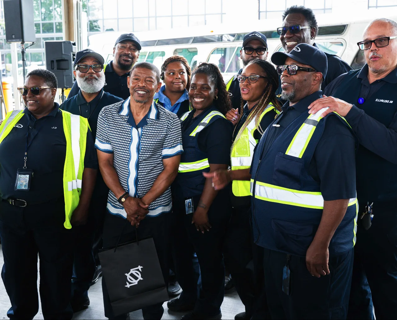 A group of smiling CATS employees in uniform